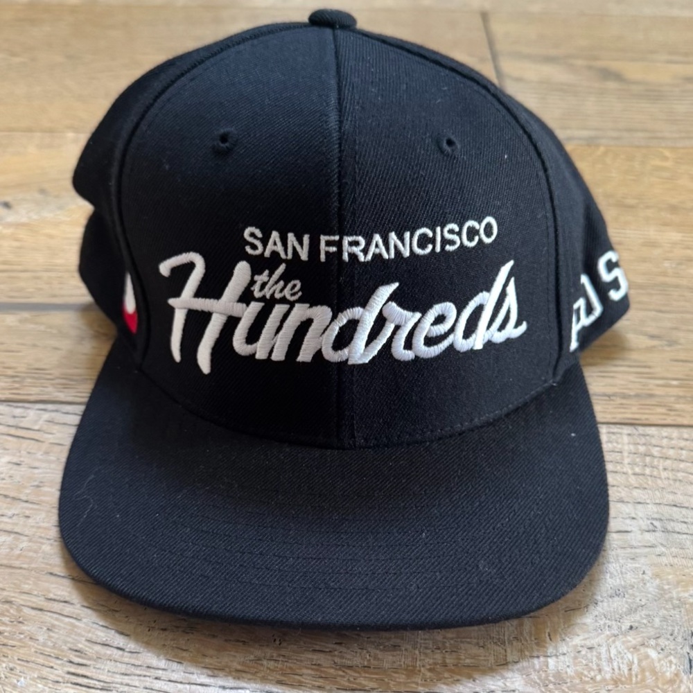 The Hundreds Black Snapback Hat with White Script and Red Accent